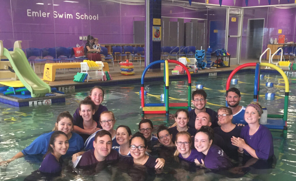 Emler's Dallas swim Instructors in a group in the pool