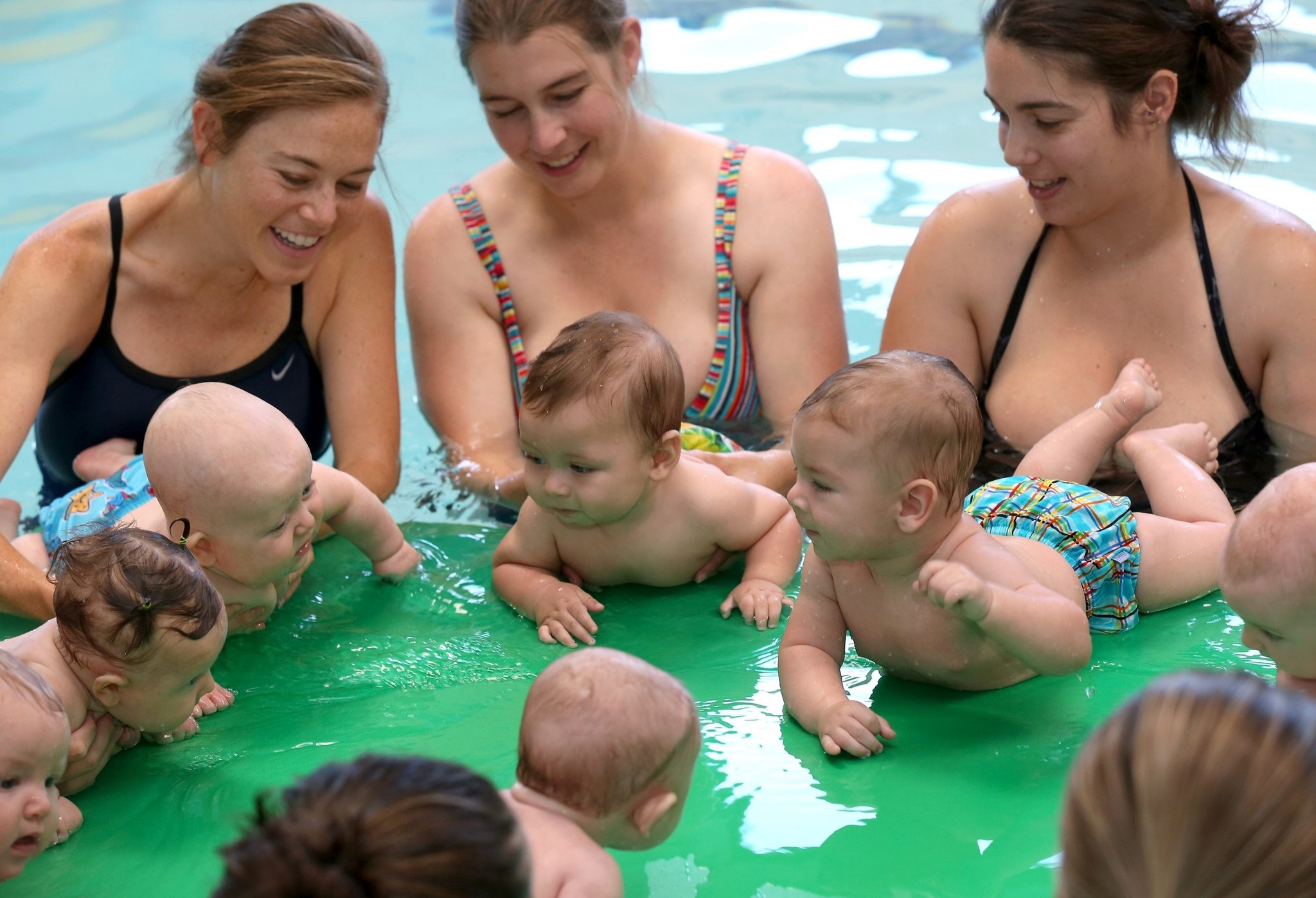 Parents swimming with their babies