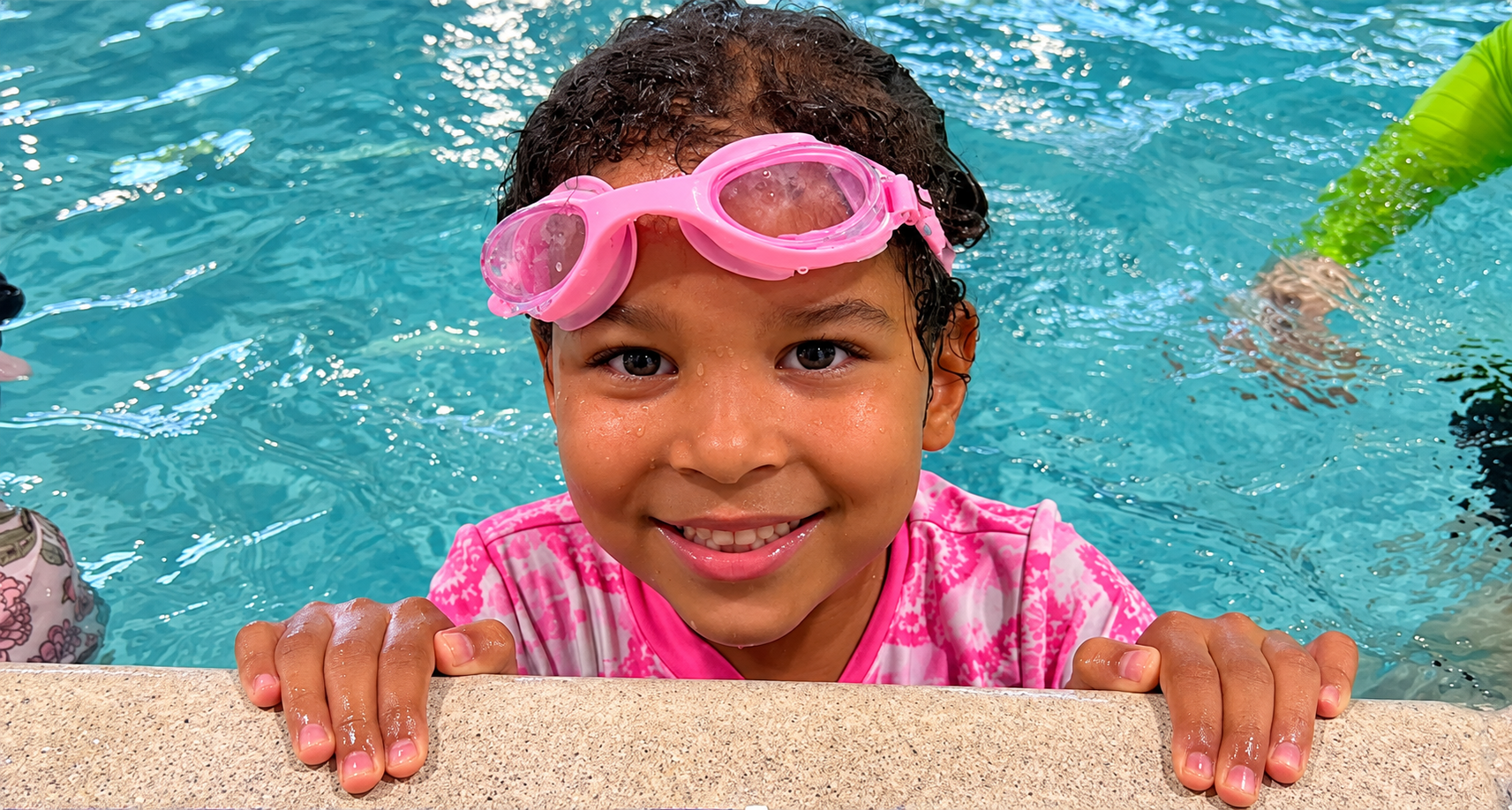 Young swimmer smiling at the pool