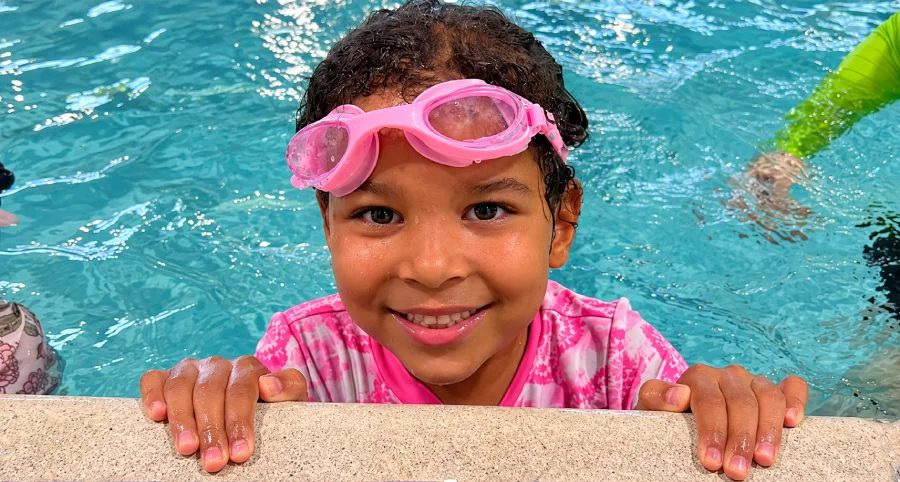 Young swimmer smiling at the pool